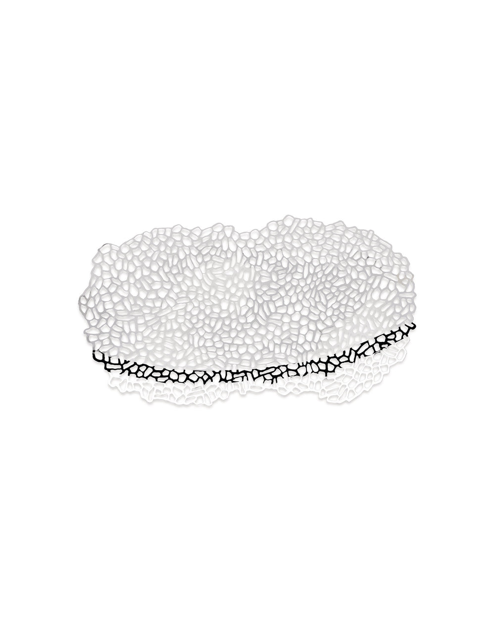 White metal centrepiece by Alessi, with an intricate organic cut-out pattern and a black reflection.