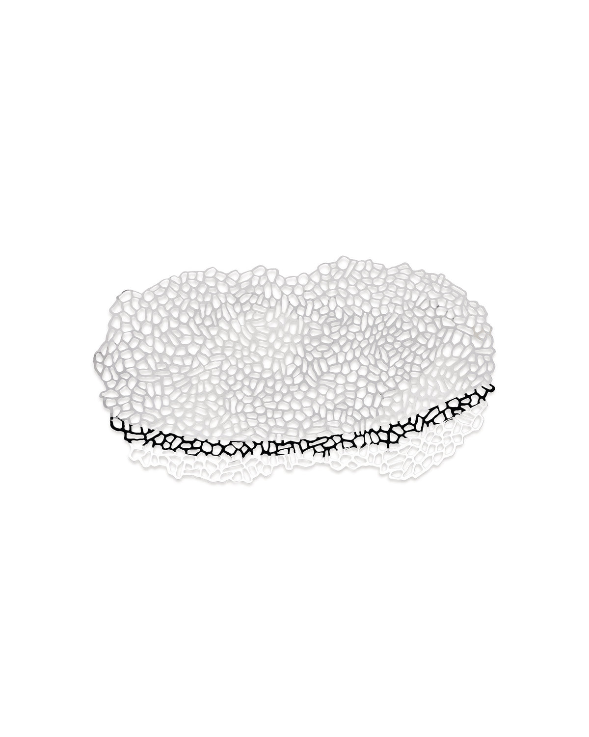 White metal centrepiece by Alessi, with an intricate organic cut-out pattern and a black reflection.