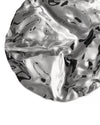 Silver-colored wavy serving plate by Alessi, featuring a highly reflective, undulating surface.