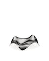 Sculptural polished metal bowl by Alessi with a wavy, reflective surface.