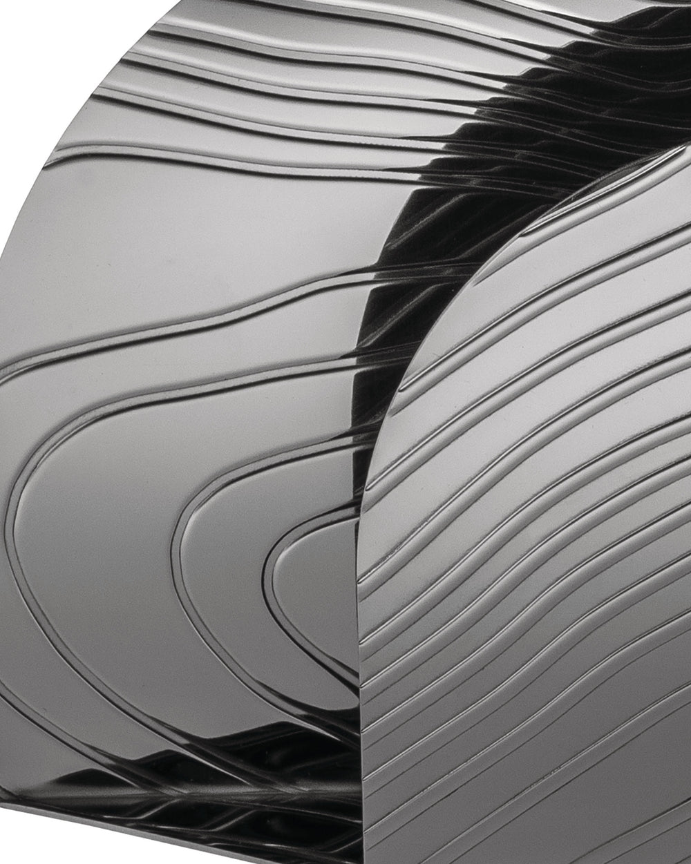 Grey metallic veneer by Alessi with a glossy finish and abstract wavy, linear patterns.
