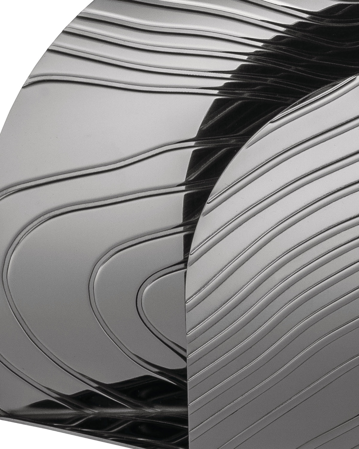 Grey metallic veneer by Alessi with a glossy finish and abstract wavy, linear patterns.