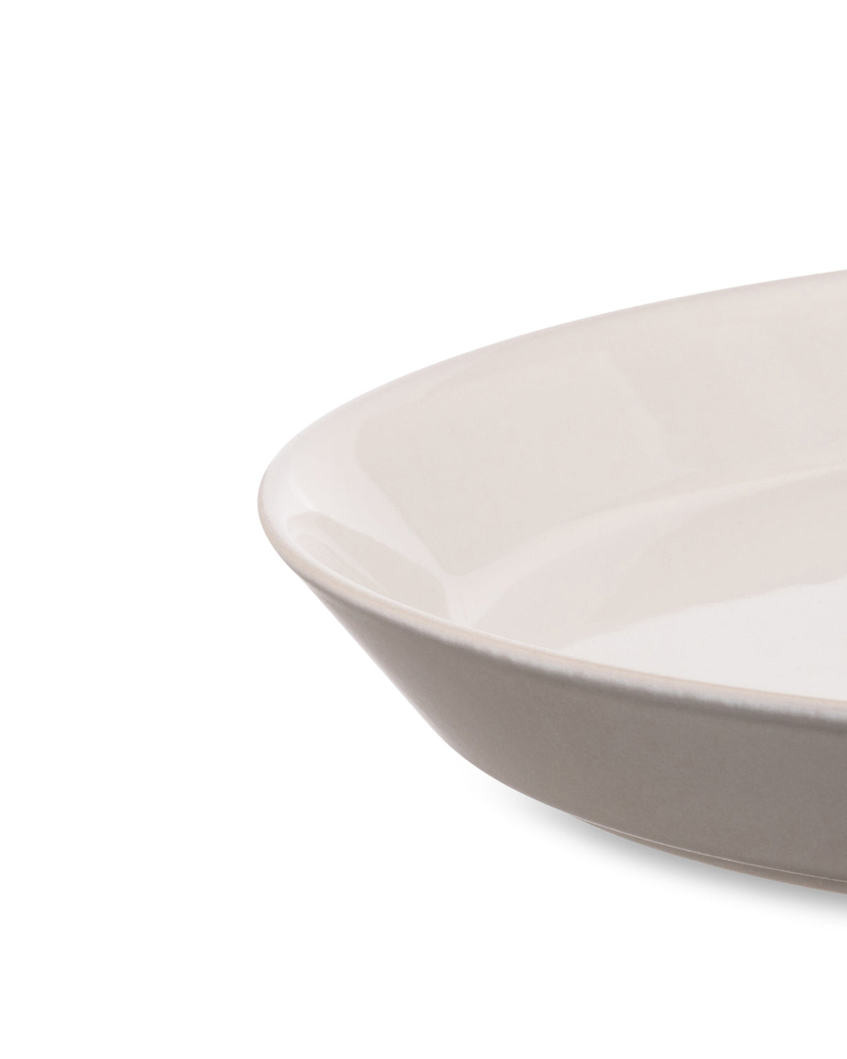 Cream white oval serving dish by Alessi with a glossy interior and a textured beige outer rim.