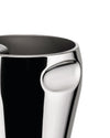 Polished chrome vessel by Alessi with a distinctive curved indentation on the side, showing a dark interior.
