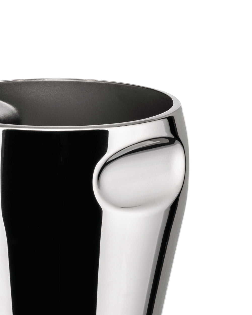 Polished chrome vessel by Alessi with a distinctive curved indentation on the side, showing a dark interior.