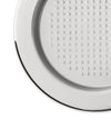 Cropped round silver metal plate by Alessi, with a grid of raised dots and a smooth rim.