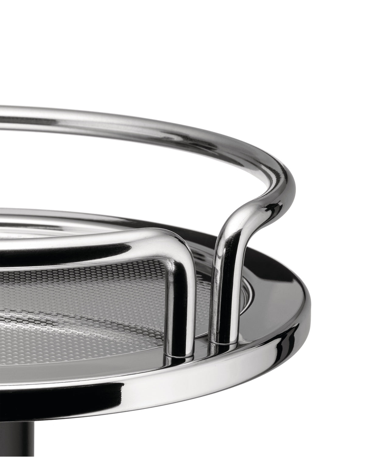 Chrome basket by Alessi featuring a perforated round base and shiny tubular rails, in a close-up.