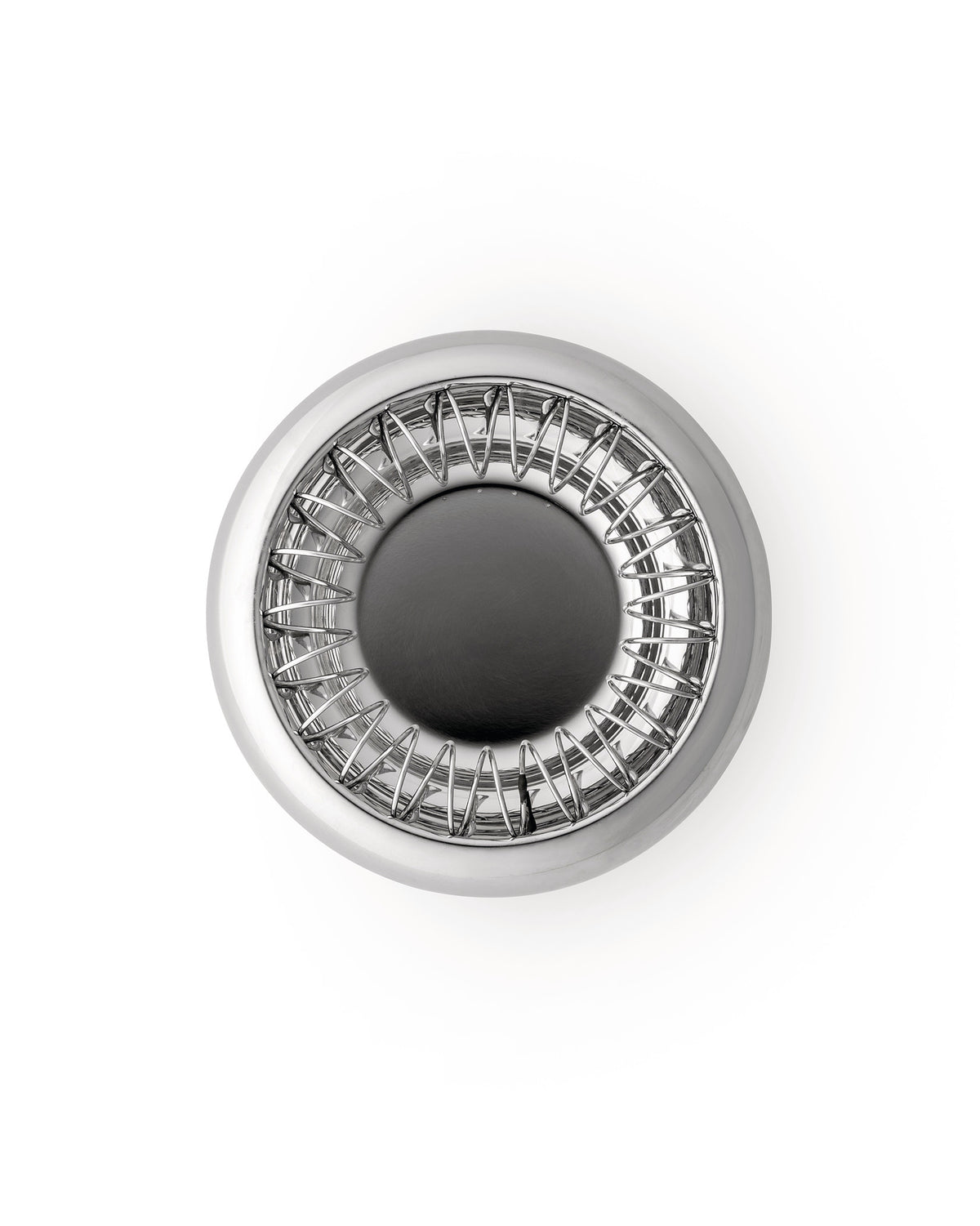 Round Spirale fruit holder by Alessi, polished metal with a distinctive wire spiral design, top-down on white.