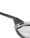 Stainless steel frying pan with black handle by Alessi, showing its highly polished, reflective interior.