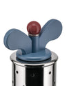 Perforated stainless steel kitchen infuser by Alessi with a blue butterfly-shaped handle and red spherical knob.