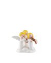 White ornamental figurines by Alessi of three yellow-haired angels playing flute and violin on a cloud base.