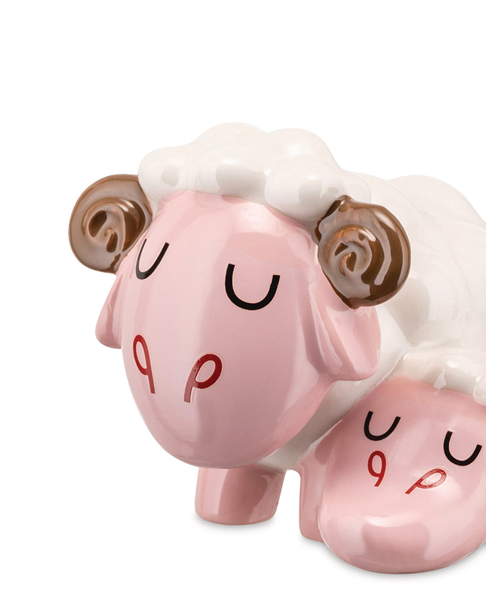 Glossy pink and white ceramic sleeping sheep figure by Alessi, with brown curled horns, black crescent eyes, and red P-shaped cheek marks.