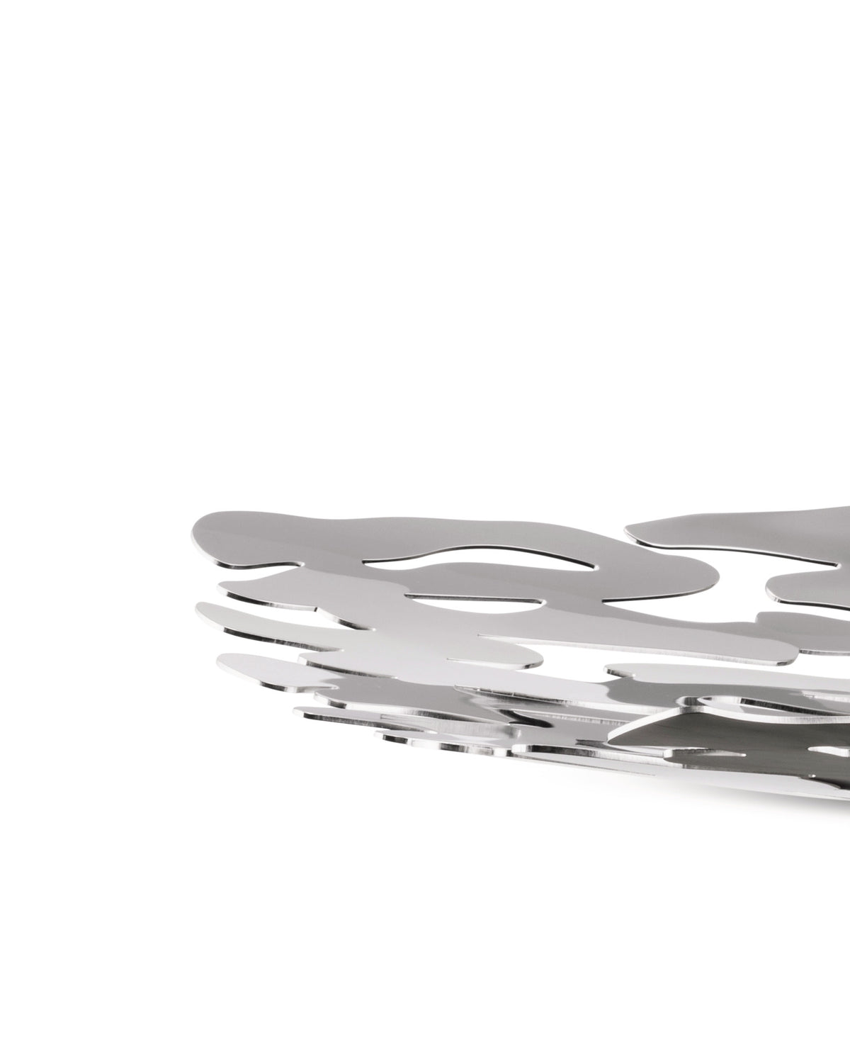 Silver metal decorative bowl by Alessi featuring a layered, intricate wavy cut-out design, cropped view.