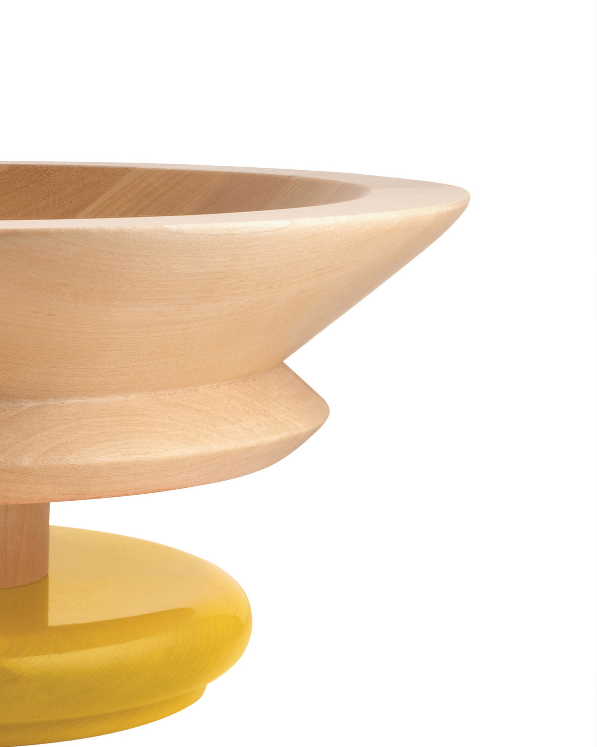 Light wood pedestal bowl by Alessi with a smooth, tapered upper section and a bright yellow glossy base, side view.