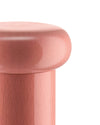 Pink kitchen mill by Alessi with a smooth, domed top and a contrasting pink wooden base, cropped view.