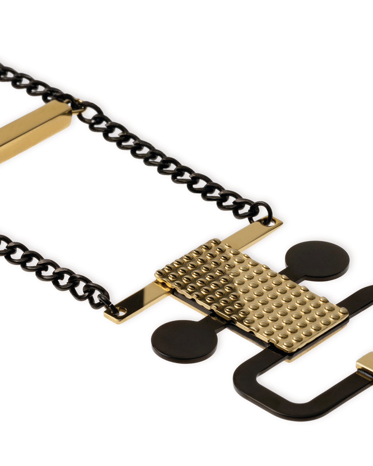 Geometric black and gold metal bracelet by Alessi, featuring a studded gold plate and smooth black shapes on a dark chain.