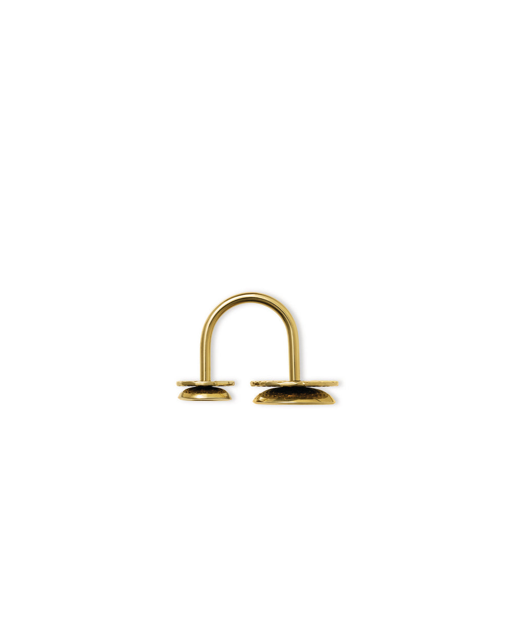 Gold Acta by Alessi, a U-shaped metal object with two textured flat bases on a white background.