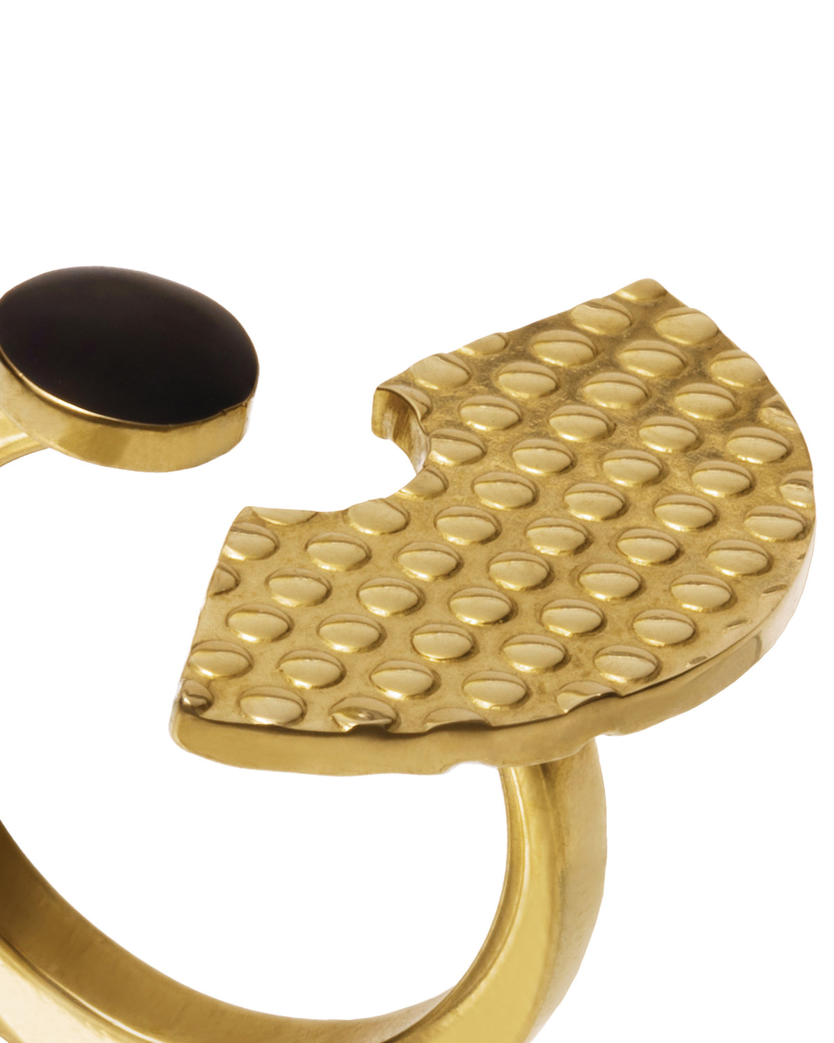 Gold ring by Alessi with an oval black stone and a textured, crescent-shaped disc.