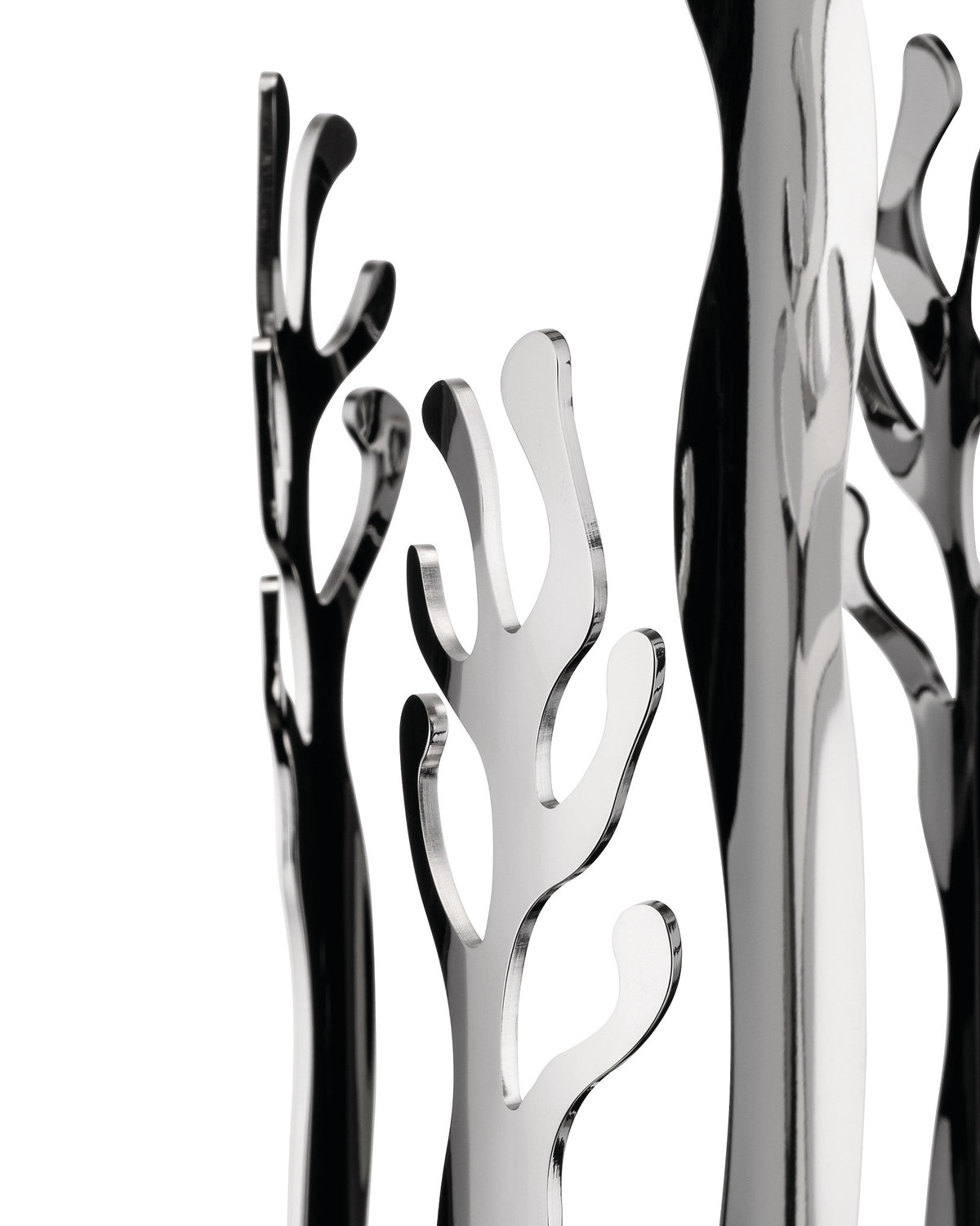 Polished silver-tone abstract sculptural decor by Alessi, featuring coral-like shapes and strong reflections against a white background.
