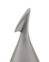 Silver metallic fruit peeler by Alessi, featuring a unique apostrophe-shaped blade, conical base, and matte texture, in a cropped view.