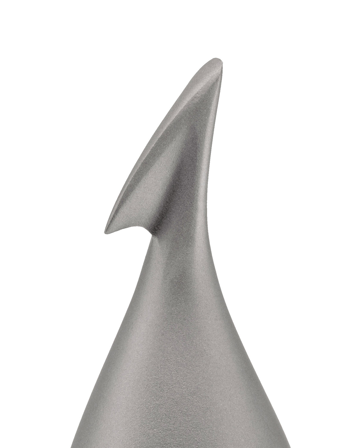 Silver metallic fruit peeler by Alessi, featuring a unique apostrophe-shaped blade, conical base, and matte texture, in a cropped view.