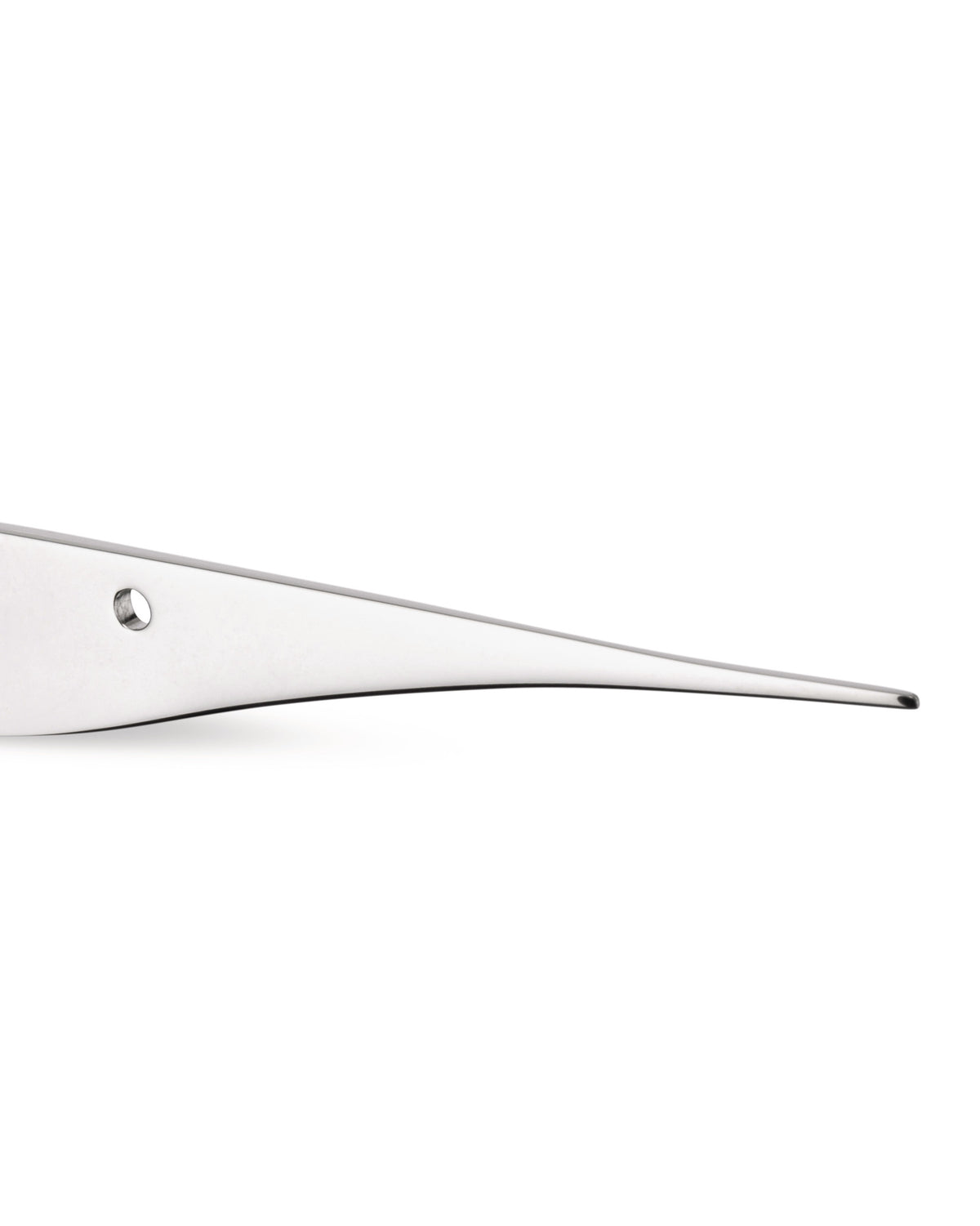 Silver-toned, flat, tapered metal utensil by Alessi featuring a small circular hole, cropped side view.