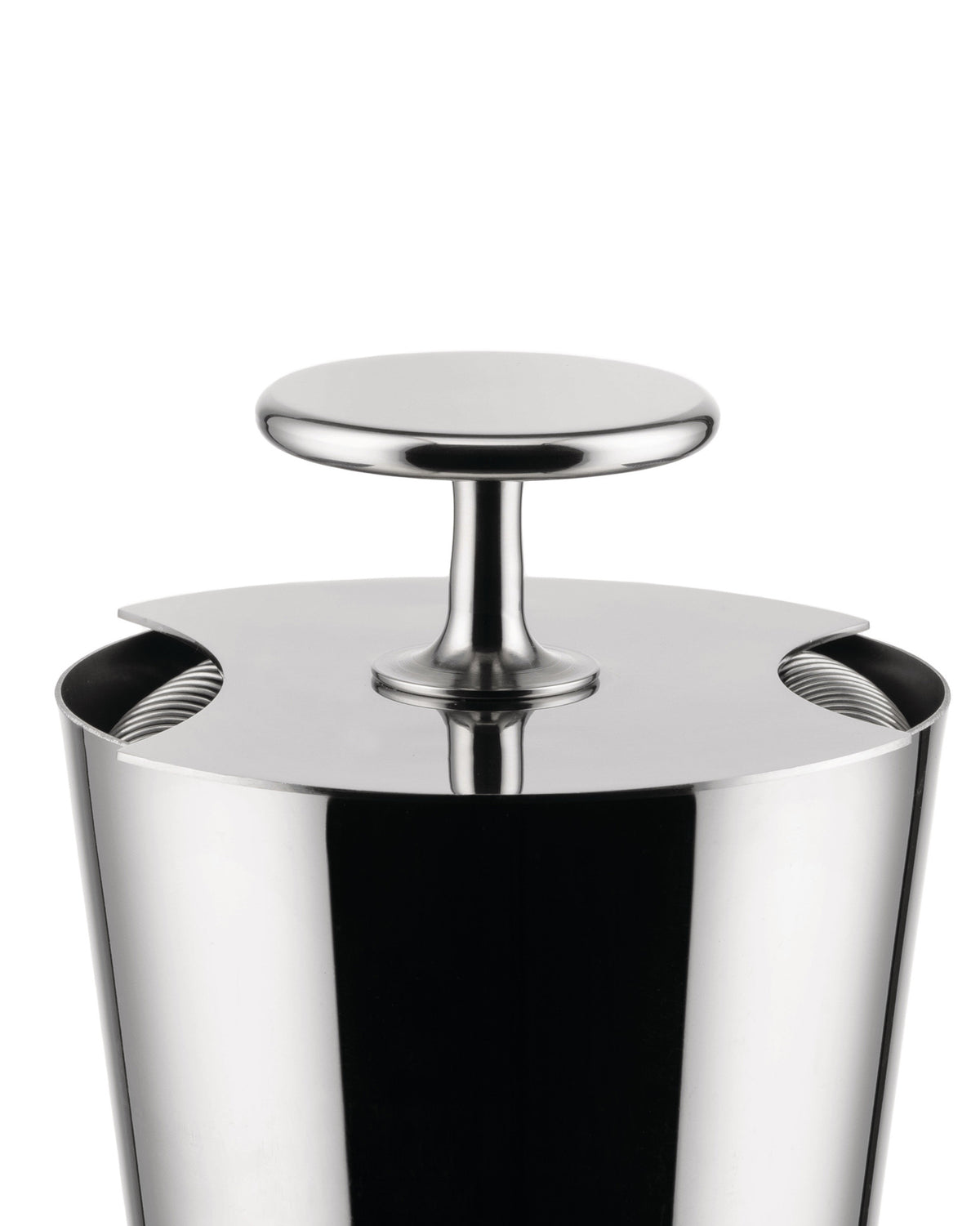 Polished metal tending box by Alessi with a sleek T-bar handle and side cut-outs revealing internal coils.