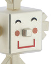 Creamy white geometric character figurine by Alessi with a smiling face, metallic nose, and red mouth.