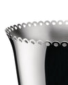 Silver metal wine cooler by Alessi with a scalloped, perforated rim in a close-up, angled view.