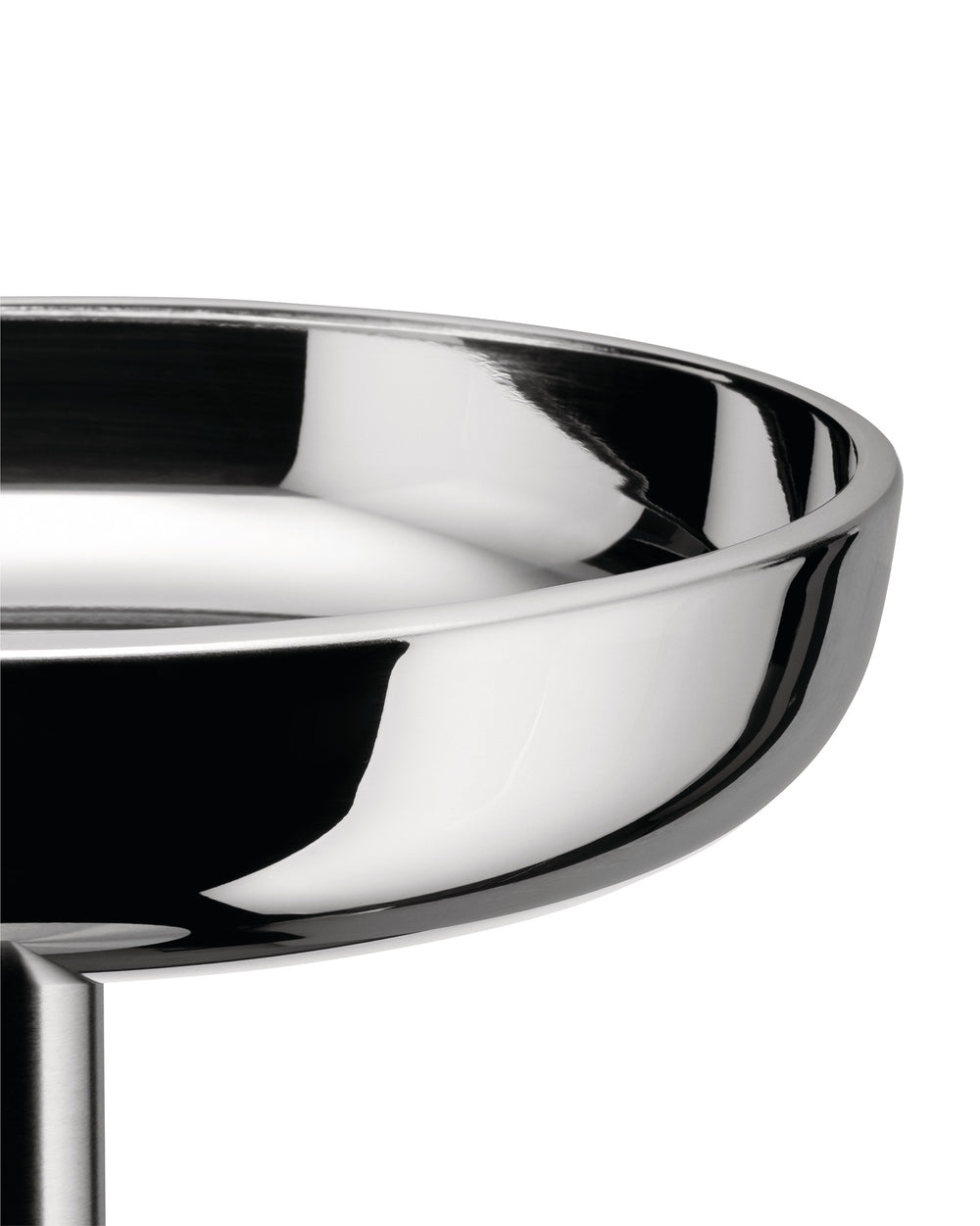 Polished stainless steel bowl by Alessi with a highly reflective, curved interior and exterior, cropped.