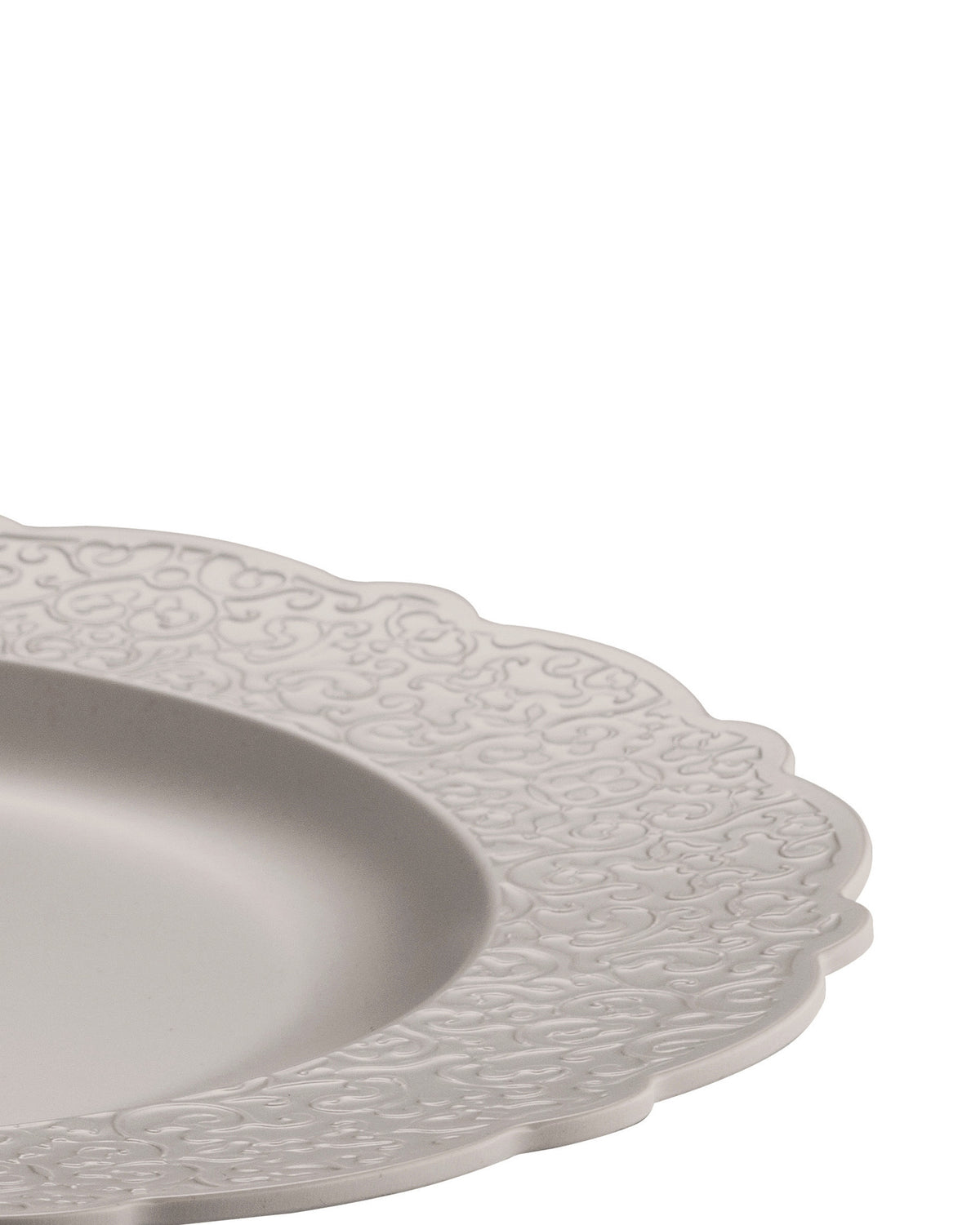 Light gray plate by Alessi featuring a scalloped edge and embossed scrollwork on the rim.