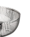 Polished silver metal decorative basket by Alessi with an open slatted, curved design, close-up.