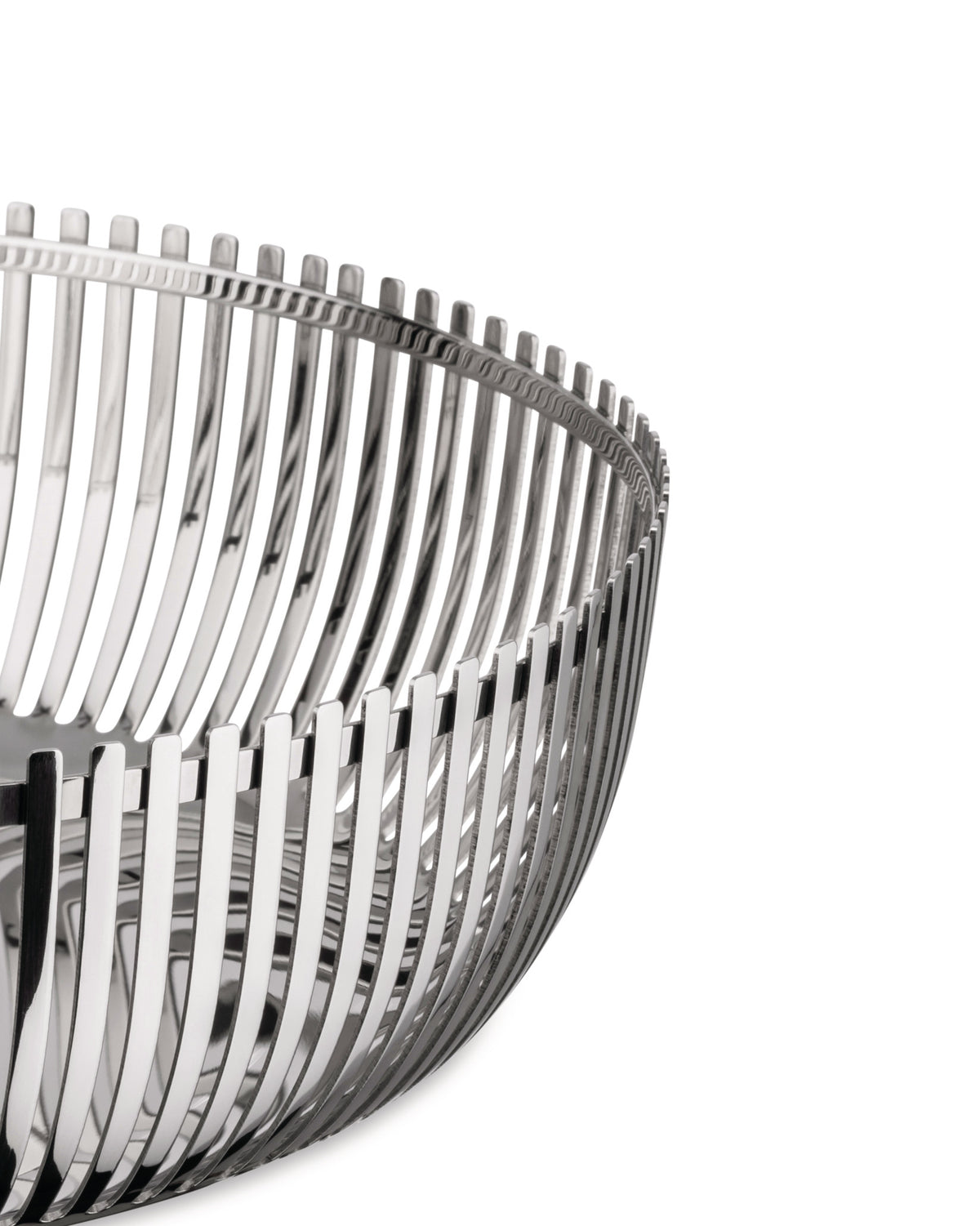 Polished silver metal decorative basket by Alessi with an open slatted, curved design, close-up.