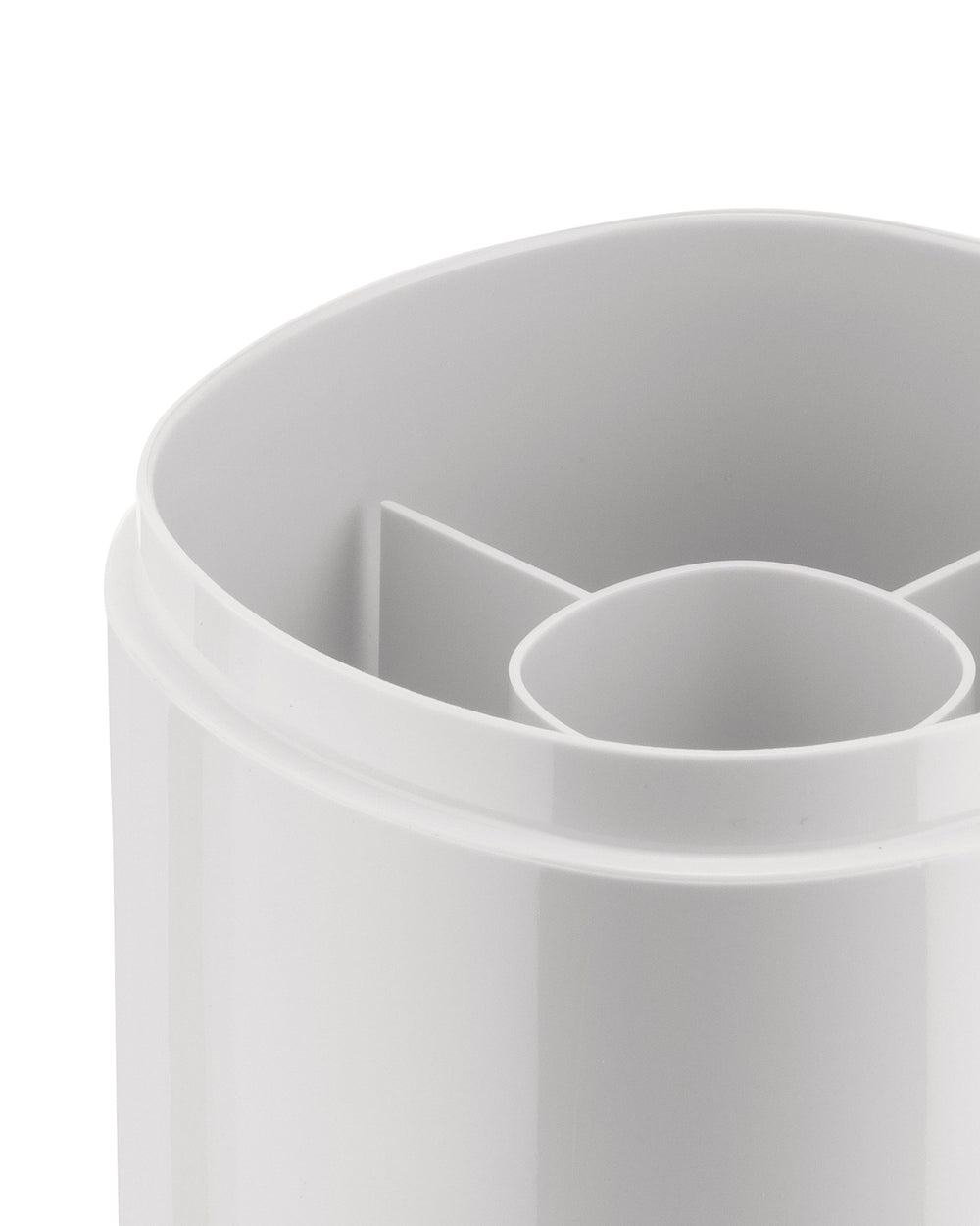 White plastic compartmental organizer by Alessi, captured in a close-up showing rounded edges and internal dividers.
