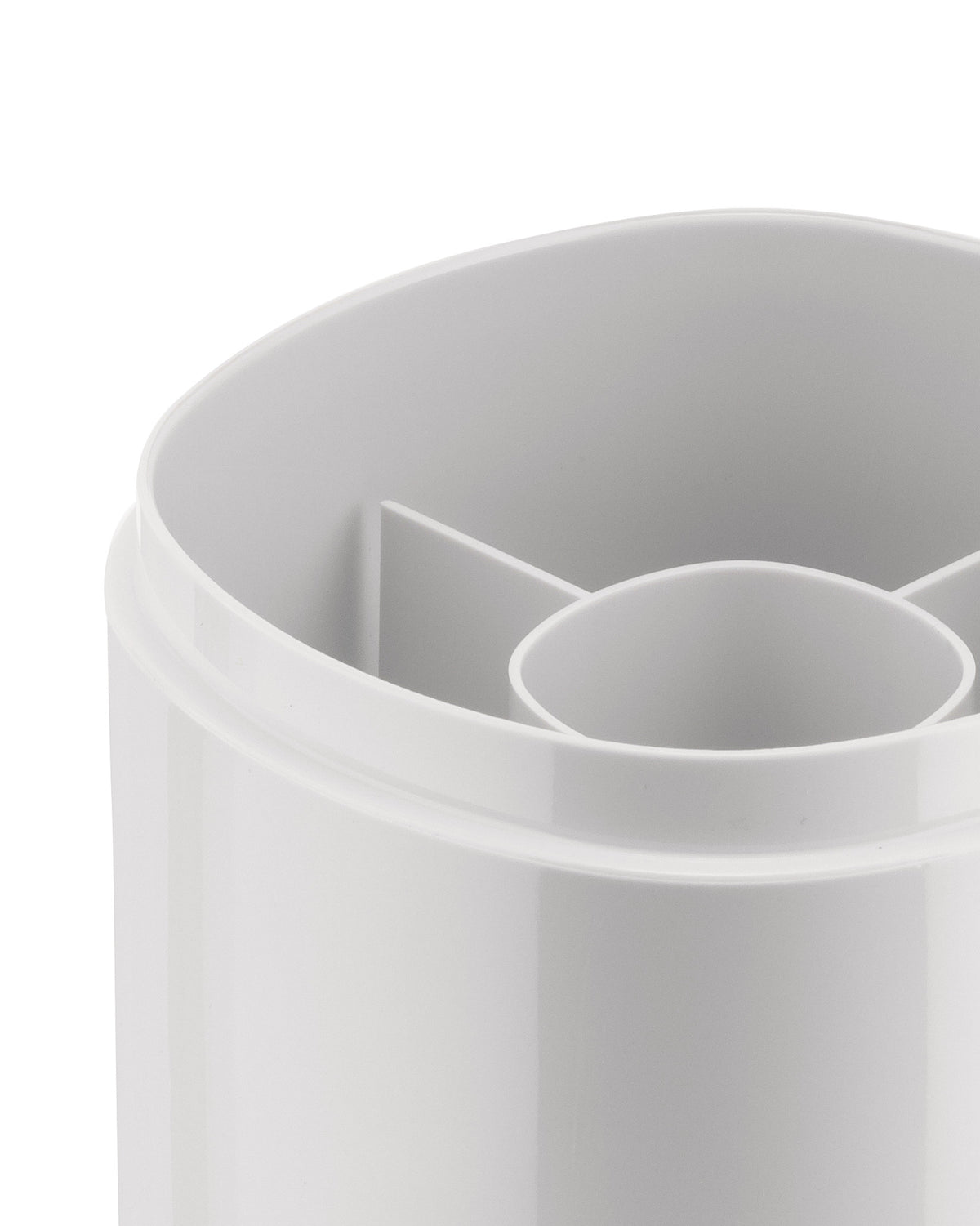 White plastic compartmental organizer by Alessi, captured in a close-up showing rounded edges and internal dividers.