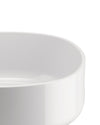 White, smooth bowl by Alessi, showing its curved interior and glossy surface in a close-up.