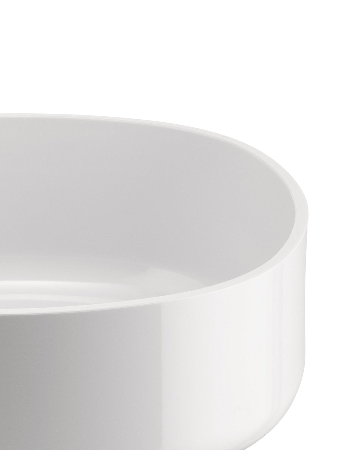 White, smooth bowl by Alessi, showing its curved interior and glossy surface in a close-up.