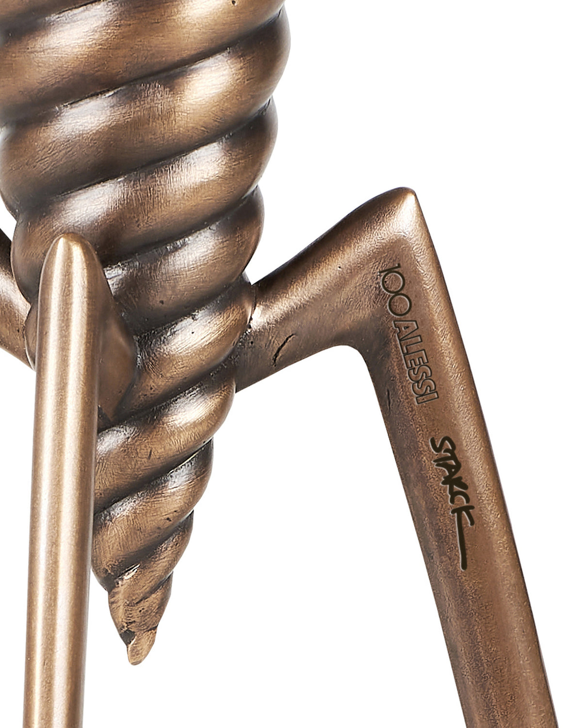Bronze sculptural object by Alessi with twisted form and engraved '100 ALESSI STAKC'.