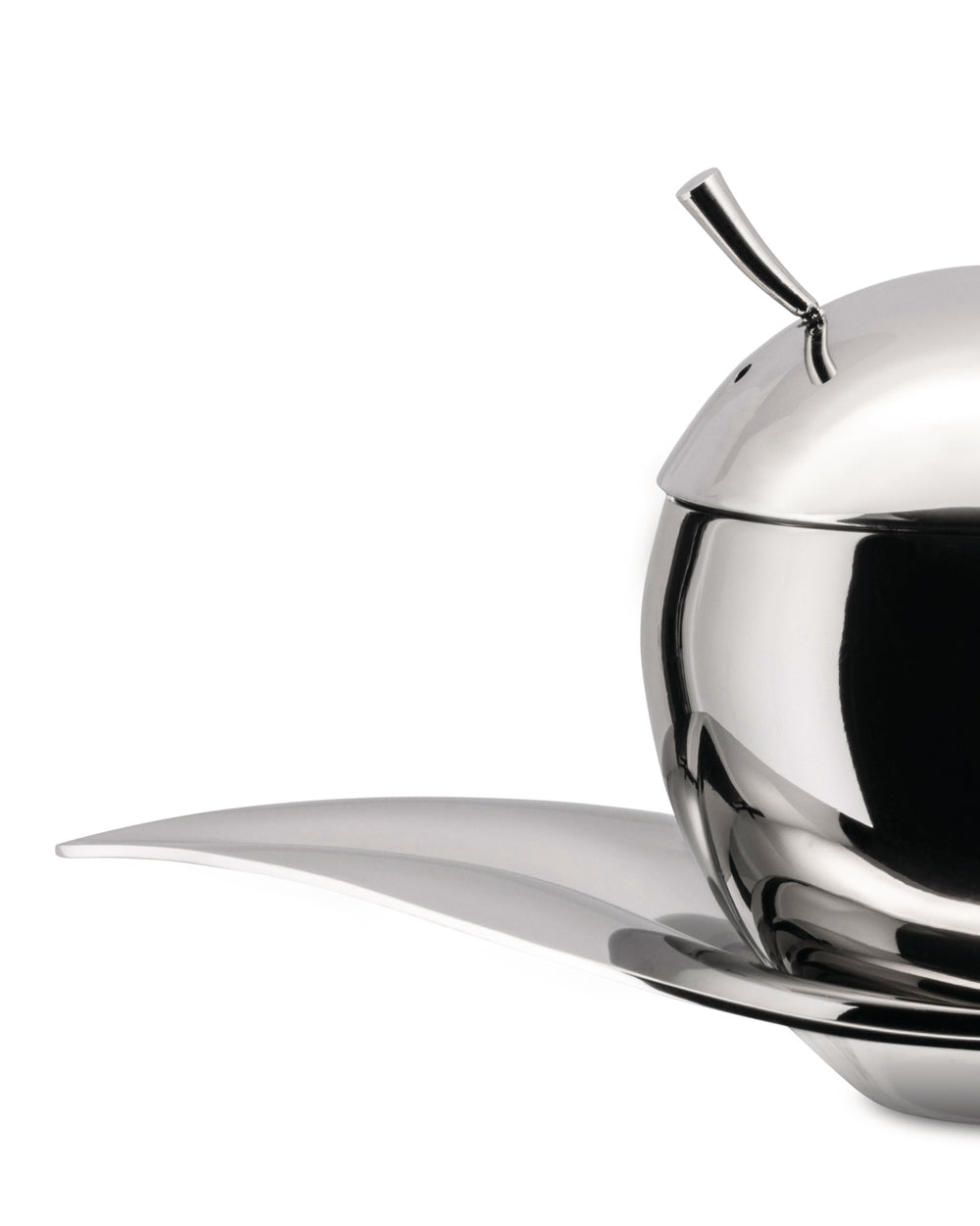 Polished stainless steel oil cruet by Alessi, sphere-shaped with a curved spout, on a leaf-shaped tray, cropped side view.