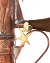Copper coffee pot with heart and stars by Alessi, showing tarnished texture in a close-up crop.