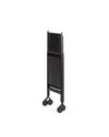 Black folding trolley by Alessi, upright with small black wheels and red accents.