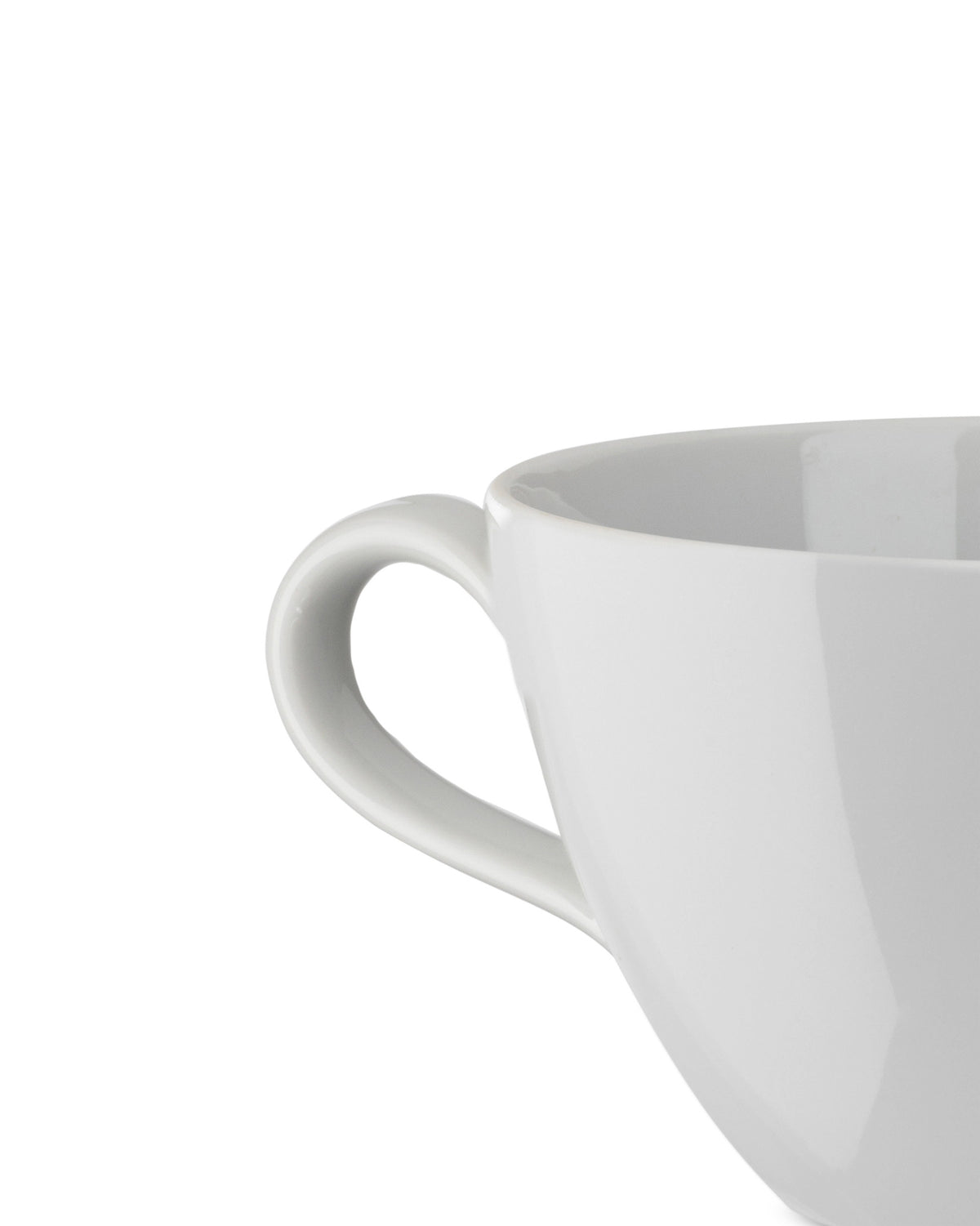 White ceramic cup by Alessi, visible from the side with a prominent curved handle.