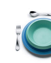 Blue and teal kids' dining set by Alessi, featuring a silver fork and spoon on white.