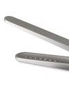 Silver metallic sugar tongs by Alessi, cropped, showing a textured jaw with raised pyramid dots.