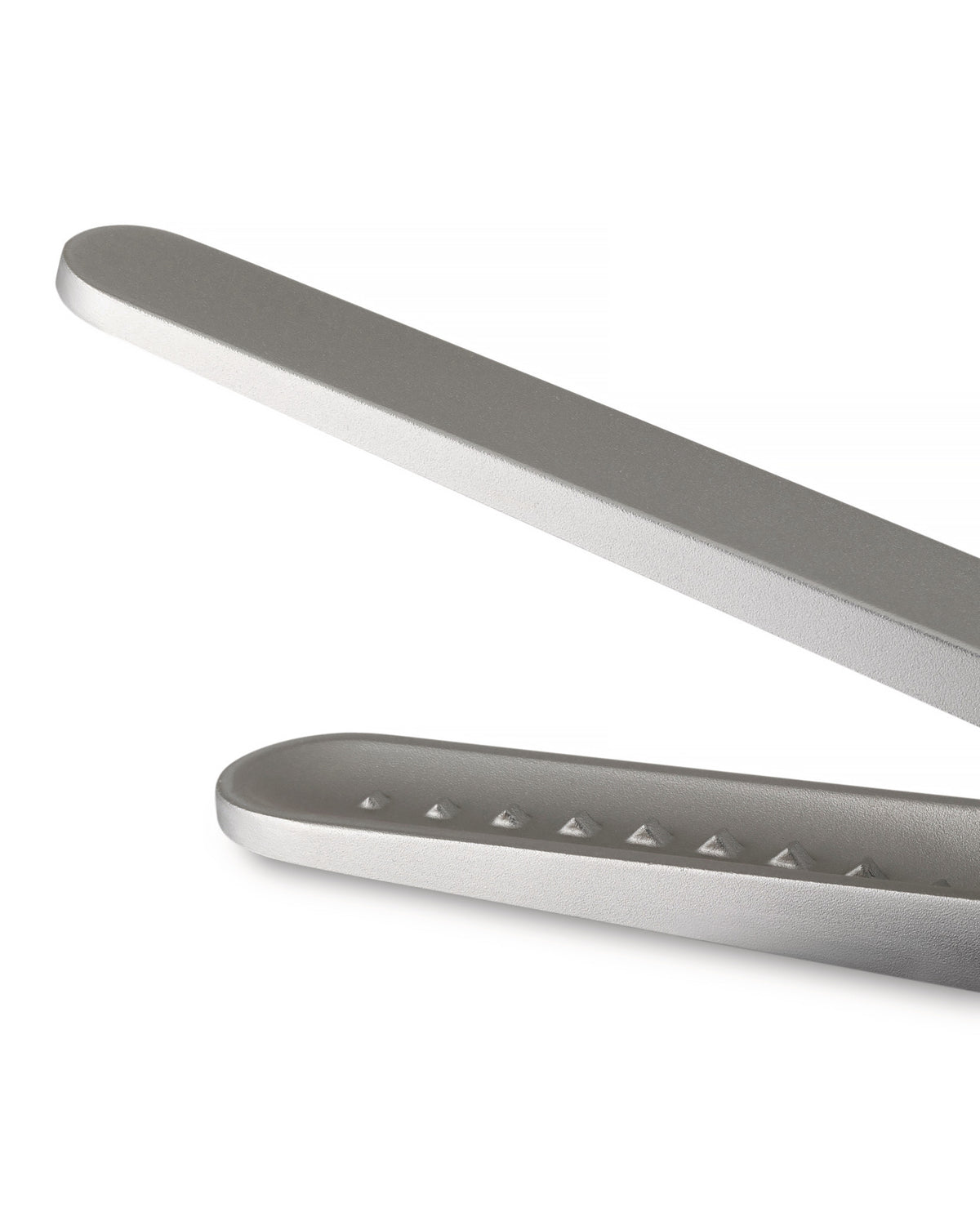 Silver metallic sugar tongs by Alessi, cropped, showing a textured jaw with raised pyramid dots.