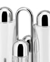 Glass and chrome oil cruet set by Alessi, with salt and pepper shakers in a polished metal stand, close-up.
