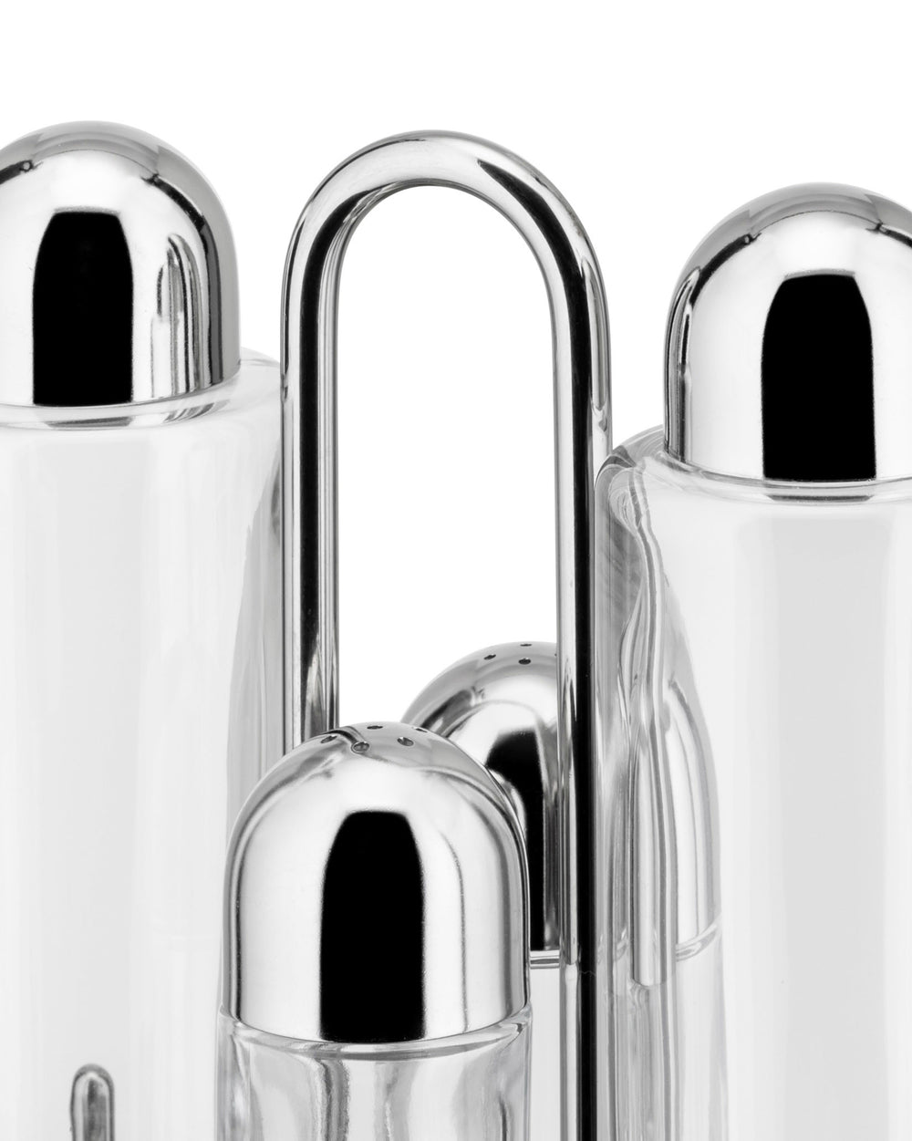 Glass and chrome oil cruet set by Alessi, with salt and pepper shakers in a polished metal stand, close-up.
