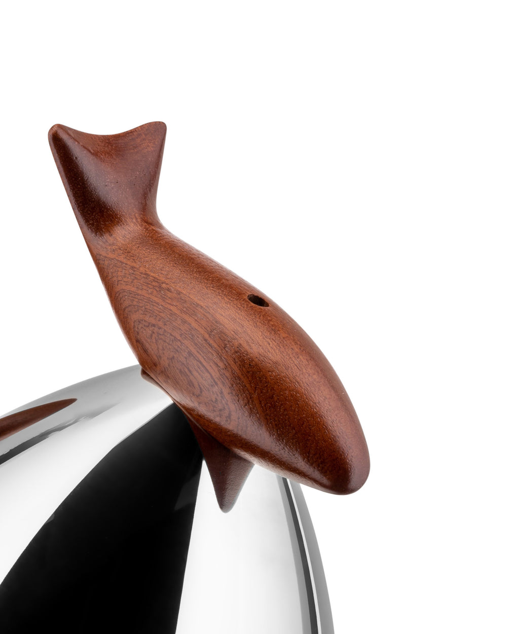 A polished metal Pito kettle by Alessi, with a dark brown wooden fish-shaped whistle handle featuring a small hole.