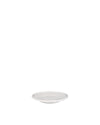 White ceramic round plate by Alessi with a raised rim and subtle central depression, low angle.