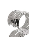 Silver metallic Barkcellar by Alessi with an intricate bark-like cut-out pattern, cropped close-up.